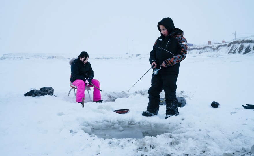 Joanna Woods, 12, (left) and her cousin Mick Chakuchin, 10, go ice fishing in Toksook Bay.