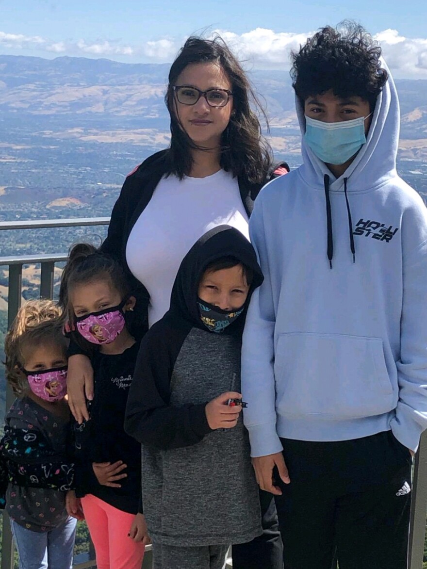 Maria Aguilar poses with her four kids (from left to right: Luna, Athena, Jio and Mauro) while hiking California's Santa Cruz mountains in August 2021. Aguilar and Luna spent four hours in line waiting for a covid-19 test in January.