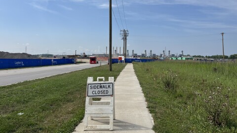 A sign near a construction zone reads, "SIDEWALK CLOSED."
