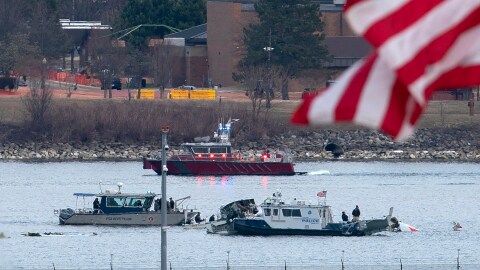A diving team and police boat is seen near a wreckage site in the Potomac River, from Ronald Reagan Washington National Airport, Jan. 30, 2025, in Arlington, Va.