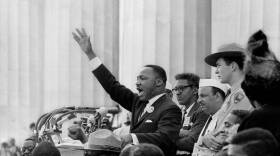 As King delivers his “I Have a Dream” speech, Bayard Rustin (in glasses) stands behind,
Gordon “Gunny” Gundrum (park ranger) eyes the crowd, and Mahalia Jackson (hat and
back of head visible) stands and shouts.
(© Bob Adelman