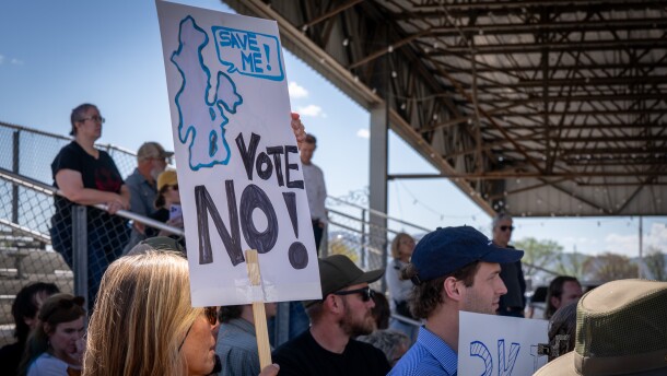 A protester waves a save the Great Salt Lake sign during a data center protest outside the special meeting of the Box Elder County Commission at the BEC Fairgrounds in Tremonton, May 4, 2026.