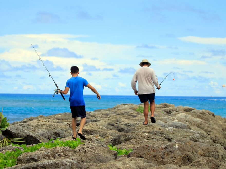 Residents go fishing this week near Tumon Beach in Guam. Some people on the strategically located island fear the president's rhetoric has exposed them to danger.