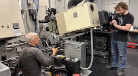 Milwaukee Film technical director Kevin Rice (right) and renowned Chicago-based projectionist James Bond work on installing brand new shutters for the projector that were manufactured specifically for the Oriental Theater's projectors.