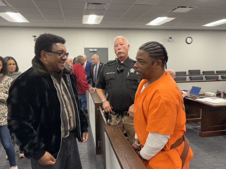 Quincy Cross, who has been in prison for the murder of Jessica Currin since 2008, talks with his father, David Cross, after the events of the evidentiary hearing wrapped up on Wednesday.
