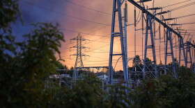 Smoke from the Eaton Fire fills the sky behind electrical infrastructure in La Cañada Flintridge on Jan. 8, 2025.
