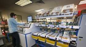 Ryan Patraw process ballots at the Marion County Clerk’s Office in Salem on Monday, May 16, 2022. Each ballot goes through several steps before it is scanned to have the vote tabulated.