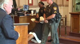 Former Judge Tracie Hunter appears to go limp when sentenced in July.