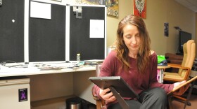 Louise Vincent sits in her office and looks at photos of Selena