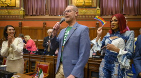 Speaking on the floor of the Connecticut House, State Representative Jeffrey Currey introduces Connecticut resident and Ru Paul’s Drag Race competitor Robin Fierce (right) at the start of pride month, June 01, 2023. A pride flag was raised above the earlier in the day where Fierce spoke saying, “For a state to raise this flag in honor of pride month may seem small and insignificant to some, but to others it gives hope. To others it shows love. To others it acknowledges that we see all of them for who they are and all of who they are.”