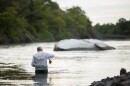 This stock image shows a fisherman at Sunken Meadow State Park.