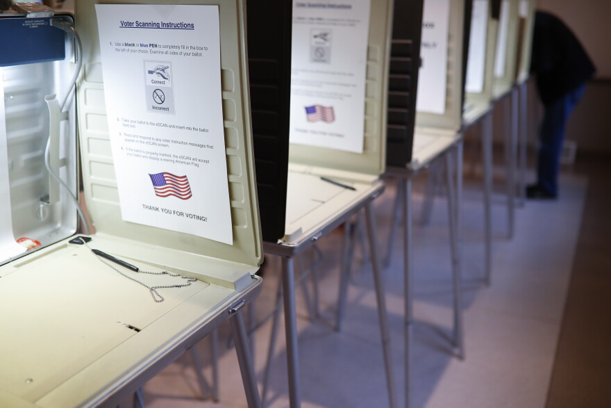 A voter fills out a ballot at a polling station in Terrace Park on Nov. 6, 2018.