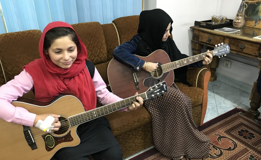 Sixteen-year-old Madina Mohammadi (right), with Mursal, never attended school before teaming up with Cordola. The guitar lessons "teach me a little bit too about life," she says.