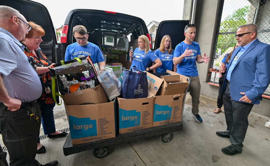 Members of Leadership Northeast's New Books on the Block team and LCCF's prison librarian and warden work to deliver books to the correctional facility. 