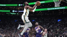 Boston Celtics guard Jaylen Brown (7) drives to the basket against Phoenix Suns forward Royce O'Neale (00) during the first half of an NBA basketball game, Thursday, March 14, 2024, in Boston. (AP Photo/Charles Krupa)