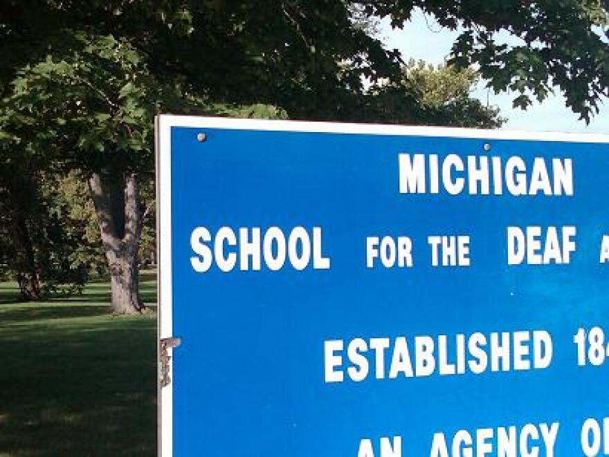 A sign stands at the entrance to the Michigan School for the Deaf in Flint