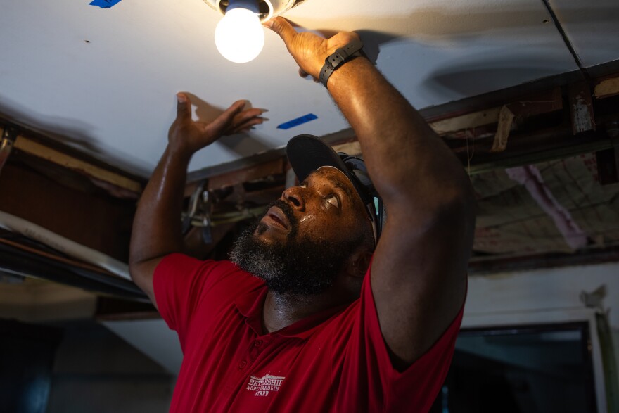 Jason Robbins, a Maintenance Tech 3, works on replacing panels in the Admiral's Cabin on board the Battleship North Carolina on August 14, 2025. Previous repairs had patched problem areas with lower quality steel, but Executive Director Dr. Jay Martin is committed to using higher quality, thicker steel that matches the original specs of the ship as closely as possible. 