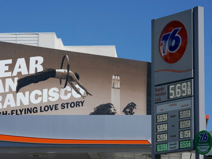 An advertisement for the show "Dear San Francisco: A High-Flying Love Story" is shown behind a price board at a gas station in San Francisco, Tuesday, March 8, 2022.