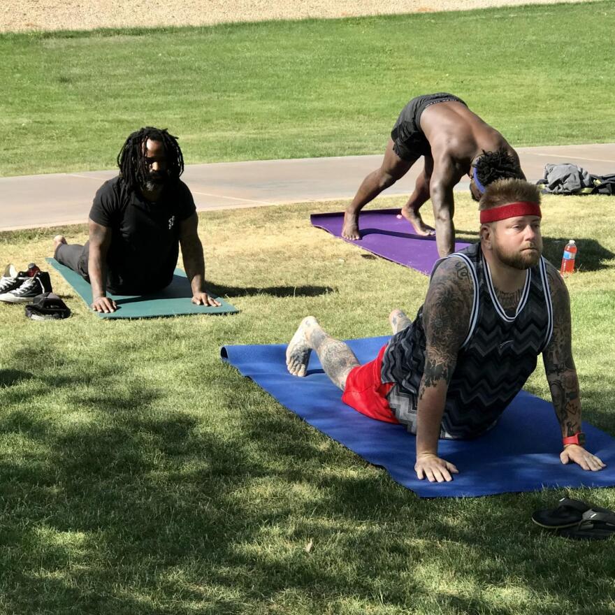 Former NFL player Ricky Williams (left) takes part in GanjaFlow yoga