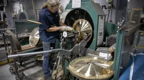 Cymbalsmith Peter Nelson works on a cymbal on a lathe at the Zildjian cymbal factory in Norwell, Mass.