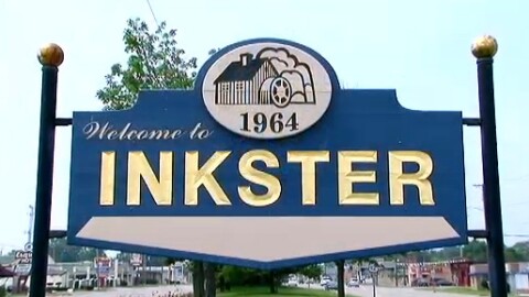 A blue sign reads "Welcome to INKSTER" in gold type.