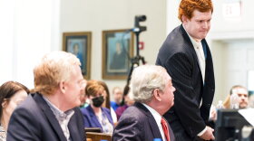 Buster Murdaugh, right, the son of Alex Murdaugh, walks to the witness stand as his father, left, looks on during his trial at the Colleton County Courthouse in Walterboro, S.C., on Tuesday, Feb. 21, 2023. The 54-year-old attorney is standing trial on two counts of murder in the shootings of his wife and son at their Colleton County, S.C., home and hunting lodge on June 7, 2021. (Jeff Blake/The State via AP, Pool)