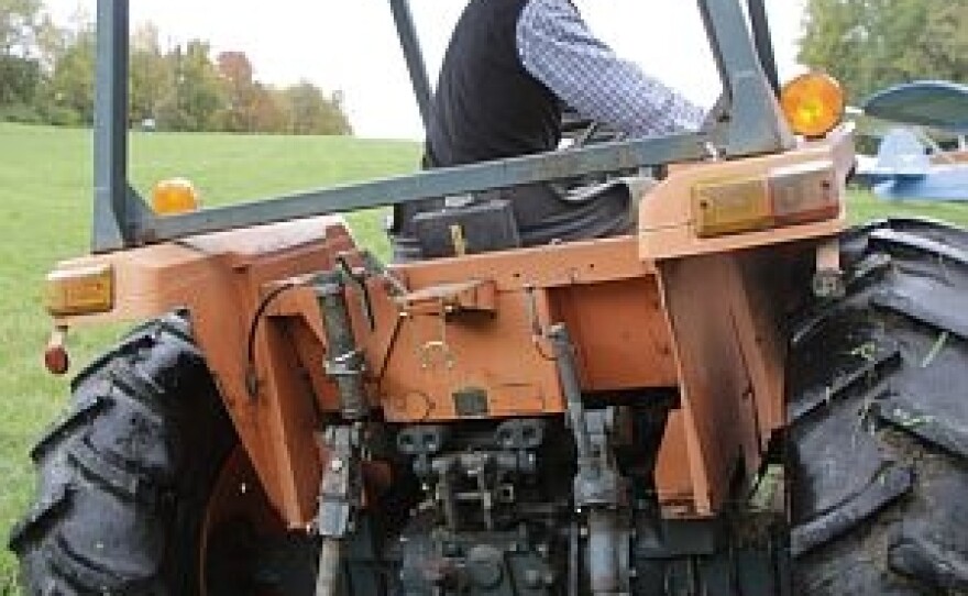 Matt Myers, coordinator of the Rollover Protective Structures program for the UVM Extension Service, sits in a tractor with a