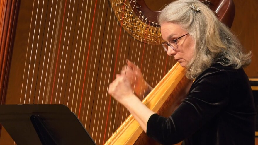 Joan Holland plays the harp. 