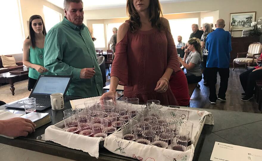 Those attending Bible study at Brody and Liz Olson's home take communion.