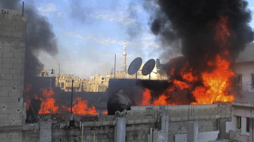 Flames rise from a house, the result of Syrian government shelling, in the Baba Amr neighborhood of Homs, Syria, on Wednesday, in this image provided by citizen journalists to the Local Coordination Committees.