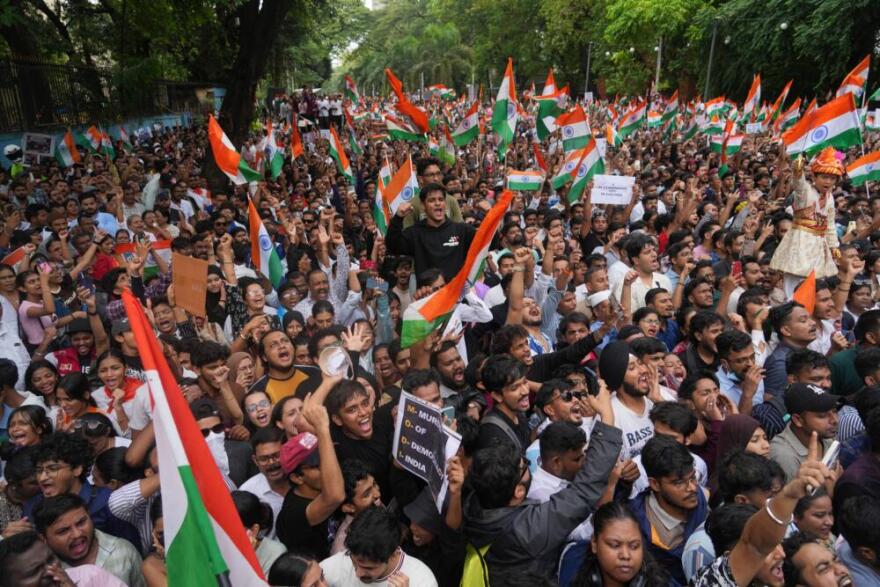 Protesters celebrate after Education Minister Dharmendra Pradhan resigned following nationwide protests as part of the Cockroach Janta Party's protest movement in Mumbai, India, Sunday, July 26, 2026. (Rafiq Maqbool/AP)