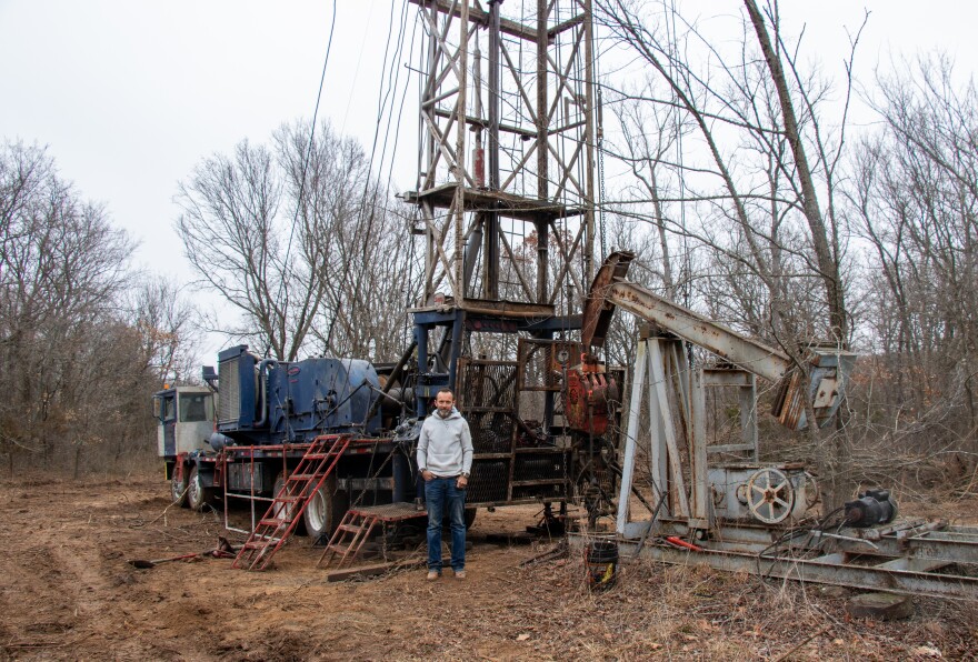 Rory Jett, owner of Southern Plains Energy Services, stands near a rig while workers take a break.