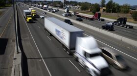 Truck and automobile traffic mix on Interstate 5, headed north through Fife, Wash., in August 2016. (Ted S. Warren/AP)