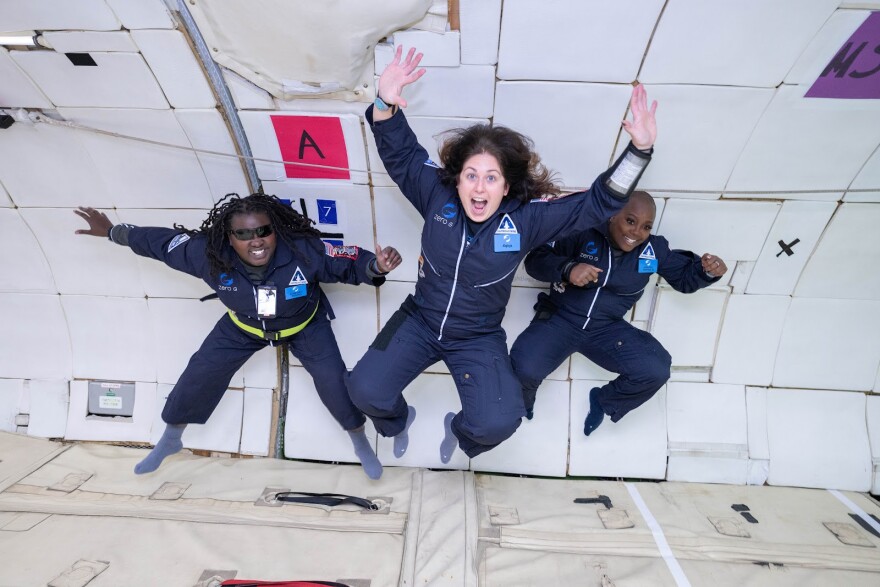 Denna Lambert, left, Victoria Garcia, center, and K. Renee Horton float in zero gravity to investigate accessibility techniques for future space vehicles and space stations onboard AstroAccess' disabled research parabolic flight conducted on December 15, 2022 at Ellington Field in Houston.