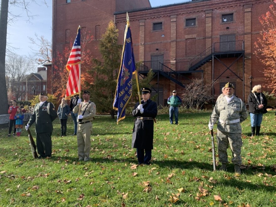 Veterans saluting the American flag at the Veterans Day ceremony at Pulaski Park in Northampton, Massachusetts.