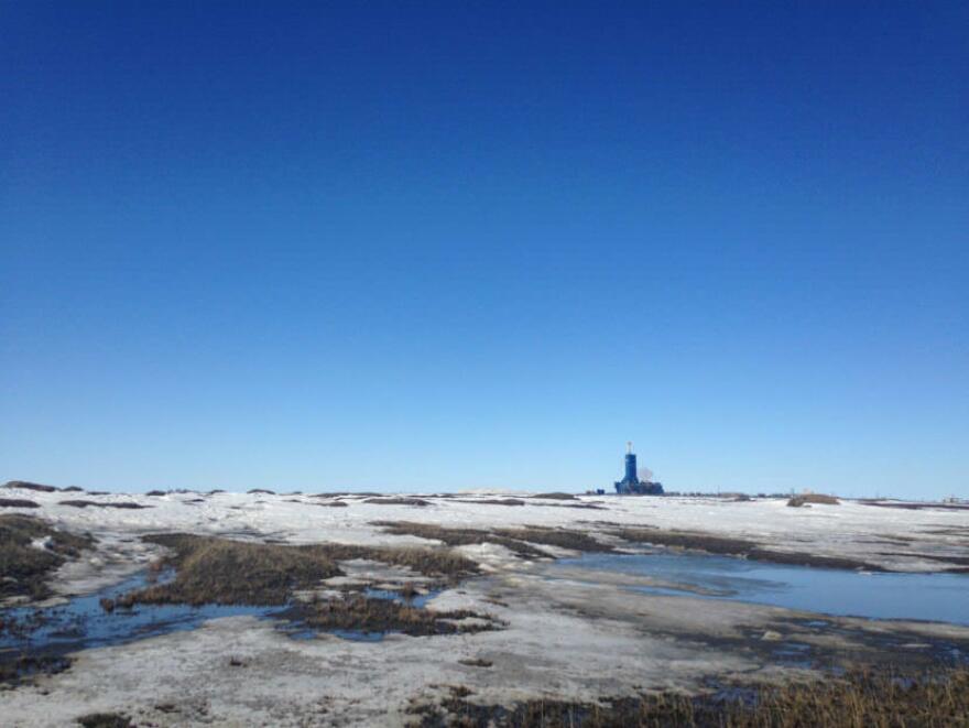 An oil rig contracting for BP looms on the horizon at Prudhoe Bay this spring. Oil revenue still makes up the bulk of Alaska’s income, the state’s revenue forecast predicts that oil prices remain too low to cover the state’s budget for the foreseeable future. (Photo by Elizabeth Harball, Alaska’s Energy Desk)