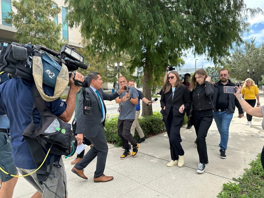 Siblings of a suspect charged in California's deadly Palisades fire walk outside of a federal courthouse in Orlando Thursday, after their brother, Jonathan Rinderknecht, was ordered to remain in jail during a detention hearing.