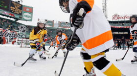 Youth teams play on an auxiliary outdoor rink before the 2010 New Year's Day Winter Classic NHL hockey game. New research shows that young players in leagues that allow checking are much more likely to suffer concussions and serious injuries than kids who play in leagues that ban it.