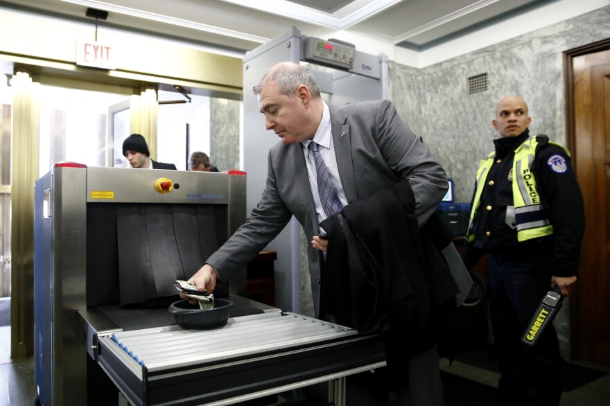 Lev Parnas, a former Rudy Giuliani associate with ties to Ukraine, collects his belongings after going through a security checkpoint during the impeachment trial of President Trump on Wednesday.