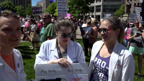  Three doctors demonstrate at an abortion rights demonstration at the Ohio Statehouse on May 14, 2022.