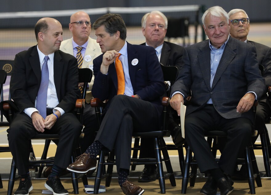 Nazareth alumnus and former NBA coach Jeff Van Gundy talks with Tim Shriver, Chair of Special Olympics International, alongside Tom Golisano at the opening of Nazareth College's 108,000-square-foot Golisano Training Center.