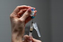 A nurse, prepares a combination measles, mumps and rubella vaccine for a patient at a pediatrics clinic in Easley, S.C. | Wisconsin Public Radio