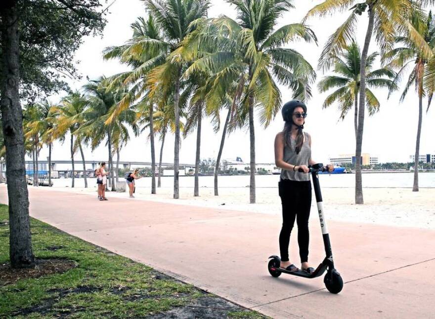 Tori Petersen rides an electric scooter in Bayfront Park, April 2, 2019.