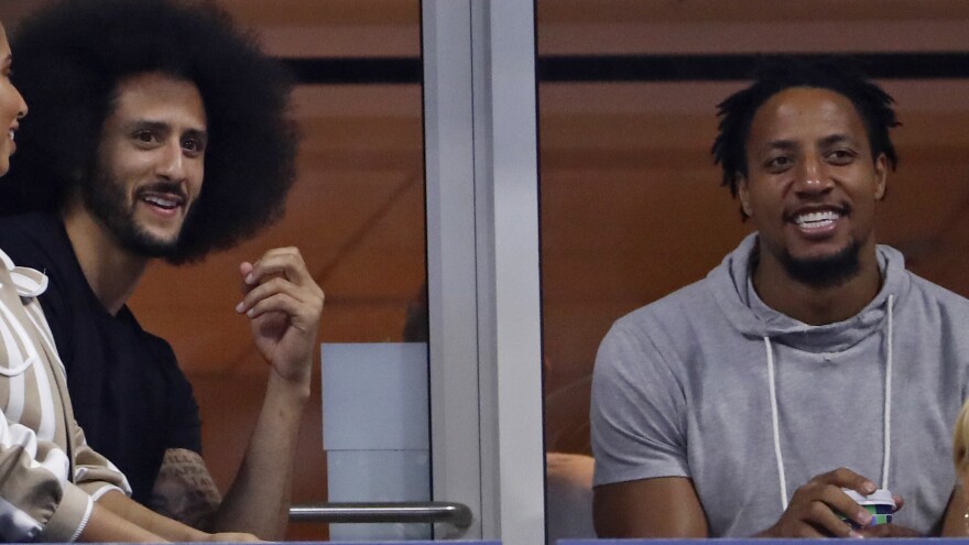 Eric Reid (right) has signed a one-year contract with the Carolina Panthers. He is seen here last month, watching the U.S. Open tennis tournament with former San Francisco 49ers teammate Colin Kaepernick.