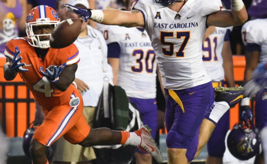 Florida wide receiver Brandon Powell (4) lays out for a catch, while being trailed by East Carolina linebacker Joe Allely (57).