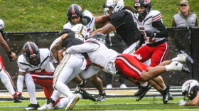 Defensive linebacker McCoy Casey tackles a Lindenwood player down on a rainy game day on Nov. 9, 2024, at Harlen C. Hunter Stadium at Lindenwood.