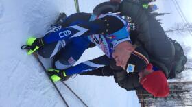 Overcome with emotion after his sprint victory, Logan Hanneman is congratulated by his father. (Dan Bross / KUAC)