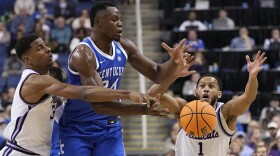 Kentucky forward Oscar Tshiebwe passes between Kansas State forward David N'Guessan and guard Markquis Nowell during the first half of a second-round college basketball game in the NCAA Tournament on Sunday, March 19, 2023, in Greensboro, N.C. (AP Photo/Chris Carlson)