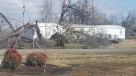 A photo of a house with a fallen tree ontop of it in Cayce Fulton, KY