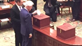 Former President Bill Clinton casts his vote for his wife, Democratic presidential candidate Hillary Clinton, at New York's Electoral College meeting in Albany on Monday.